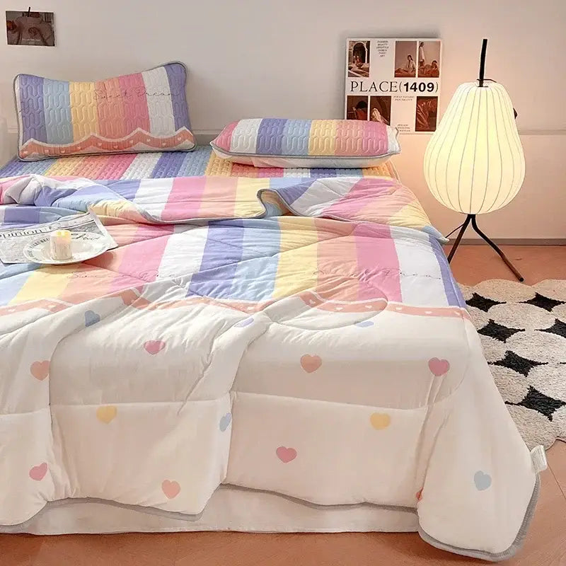 Pastel rainbow striped quilt with heart patterns and soft cotton texture paired with mint green latex fitted sheet set