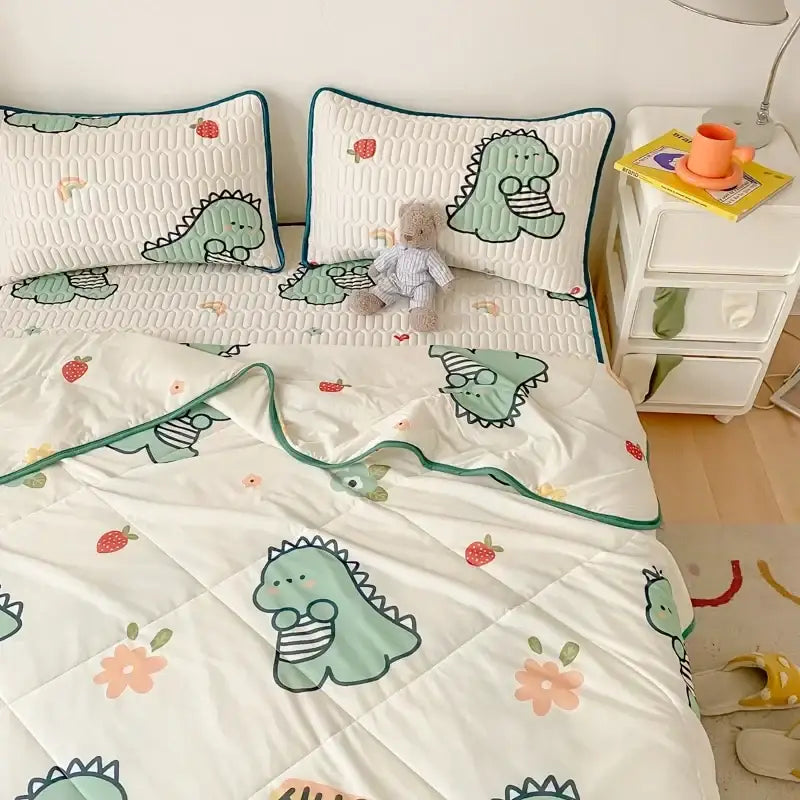 Mint green dinosaur summer quilt and latex fitted sheet set with strawberry and flower patterns on white background