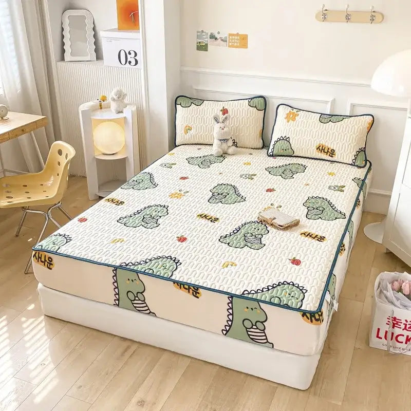 Cute mint green dinosaur summer quilt with cream base and teal trim paired with a latex fitted sheet set