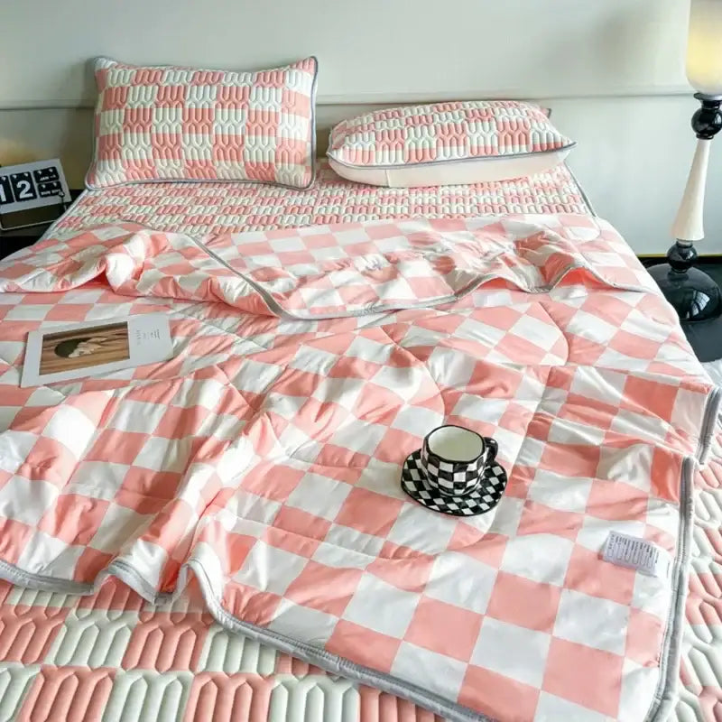 Pink and white checkered quilted bed set with matching pillow sham and mint green latex fitted sheet set for summer use