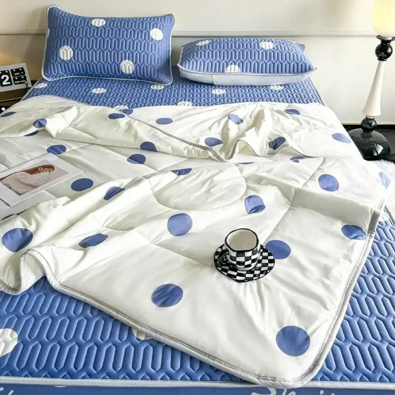 White quilt with blue polka dots stitched padded design in mint green dinosaur summer quilt and latex fitted sheet set bedroom