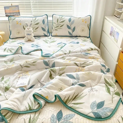White quilted mint green dinosaur summer quilt with delicate leaf floral pattern and teal piping with latex fitted sheet set