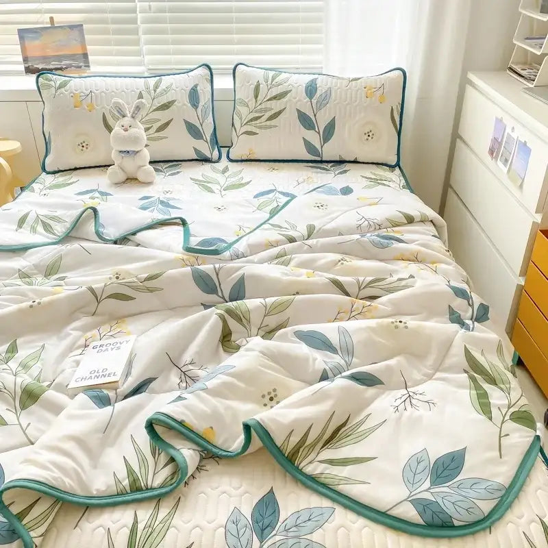 White quilted mint green dinosaur summer quilt with delicate leaf floral pattern and teal piping with latex fitted sheet set