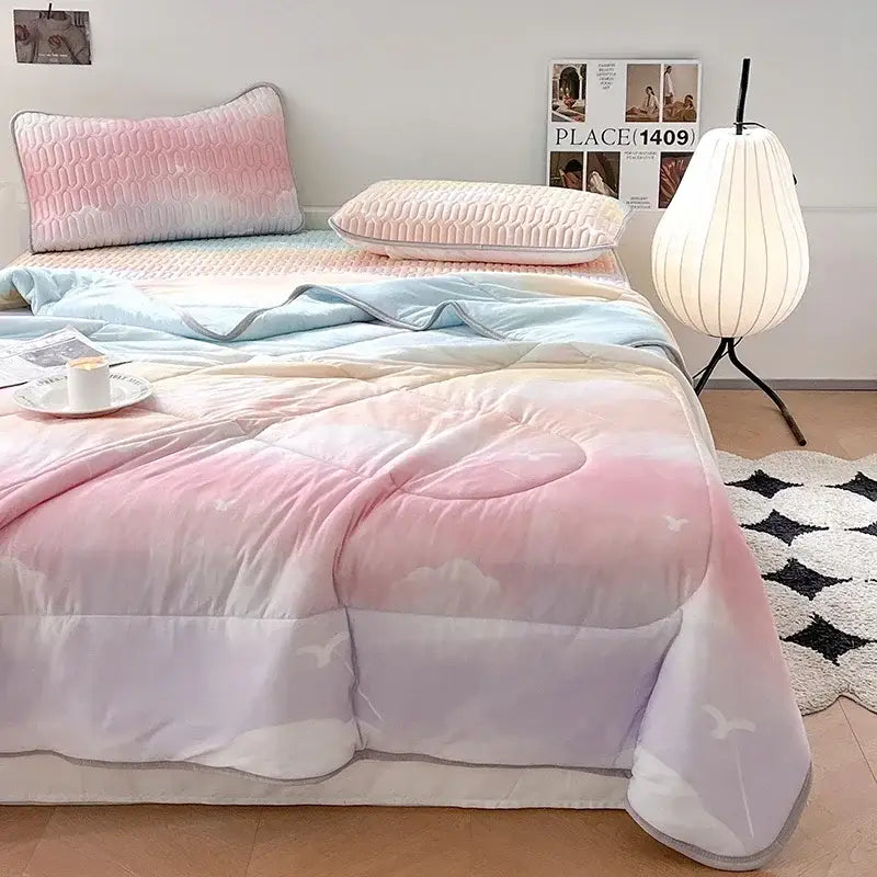 Pastel gradient cloud-patterned quilt in soft pink lavender and blue with latex fitted sheet set for summer bedroom