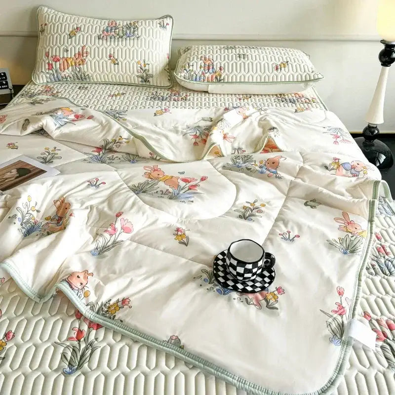 Cream-colored quilted summer quilt with embroidered bunny floral patterns and matching latex fitted sheet set