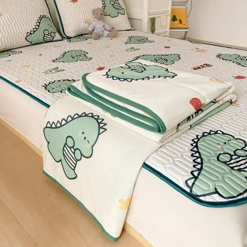 Mint green dinosaur summer quilt and latex fitted sheet set with white base and teal trim featuring dinosaur pattern