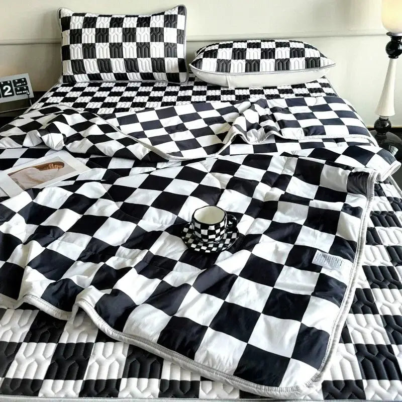 Black and white checkered quilted bed set with matching pillow sham and latex fitted sheet set for bedroom use