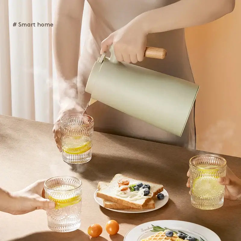 Mint green double glazed thermos kettle with wooden handle and spout designed for modern kitchen use and double glazed water retention