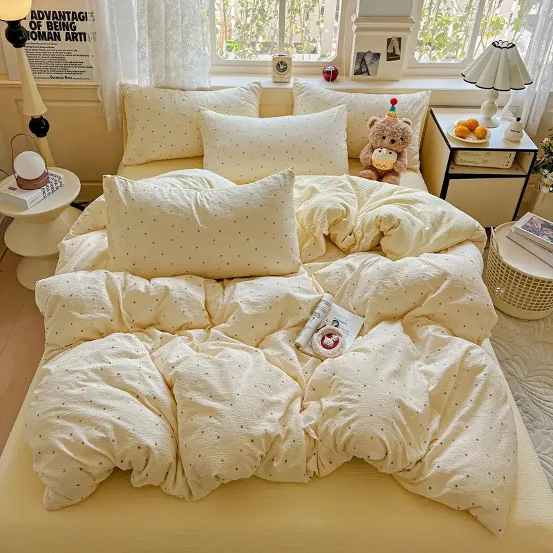 Cream-colored textured duvet cover set with subtle dark polka dots complements mint green floral yarn duvet cover set