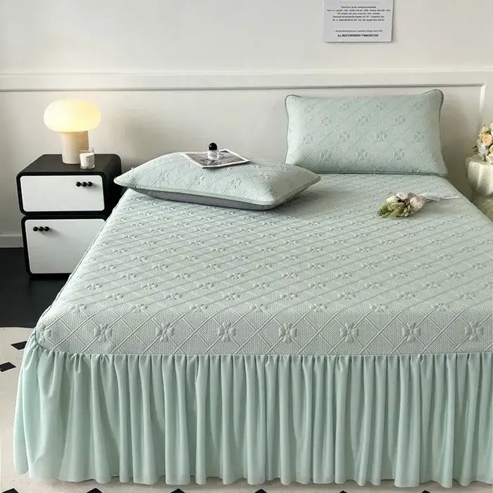 Mint green floral quilted bed skirt set with ruffled hem designed for bedroom mattress protection and decor