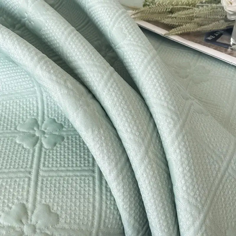 Mint green floral quilted bed skirt set with soft textured fabric and embroidered shamrock motifs for bedroom use