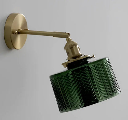 Mint green fluted glass led wall lamp sconce with textured chevron pattern mounted on a brass arm fixture