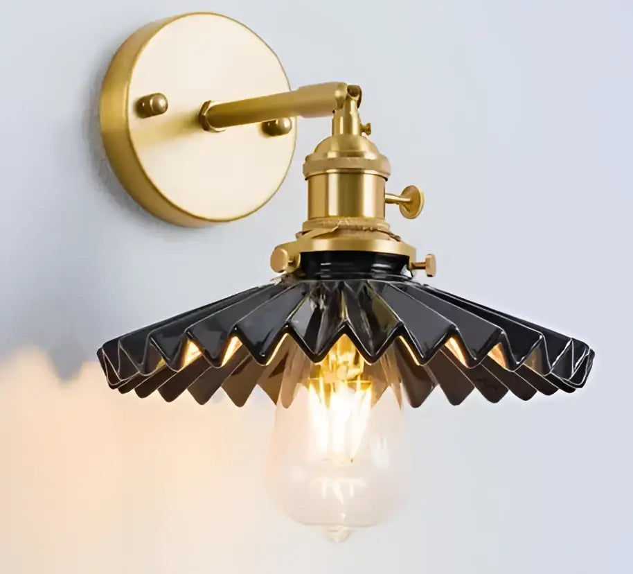 Vintage-style led wall lamp sconce with brass-finished metal frame and black scalloped glass shade for bedroom lighting