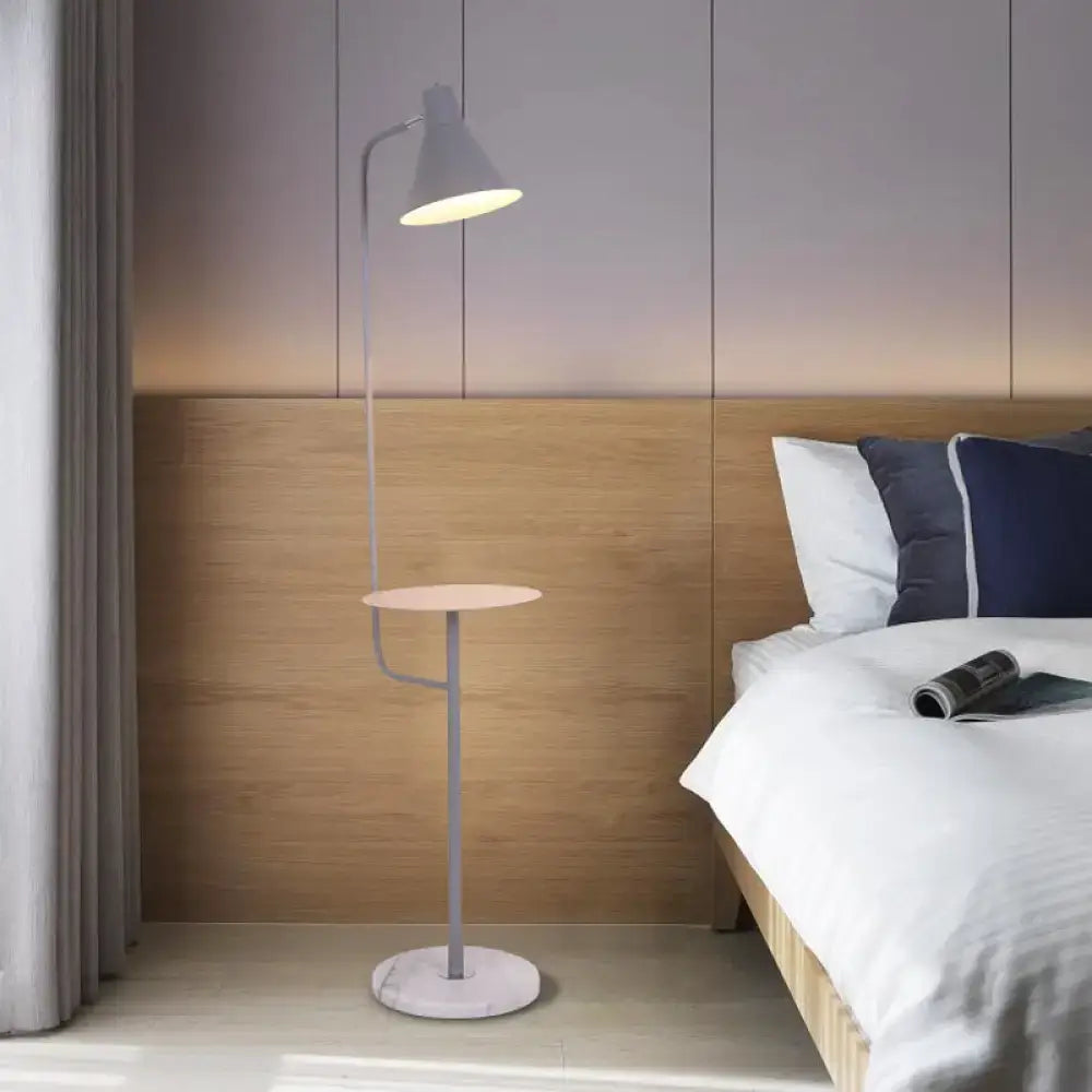 DecorBites Macaron floor lamp with sleek gray metal frame, funnel shaped metal shade, circular marble base, and warm light