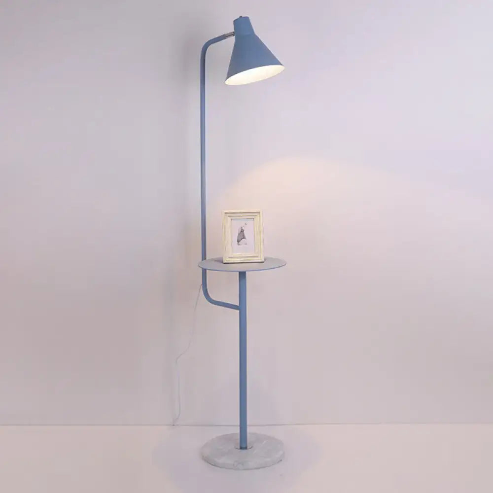 A sleek light blue DecorBites™ floor lamp with a metal shade and funnel shaped design featuring a side table