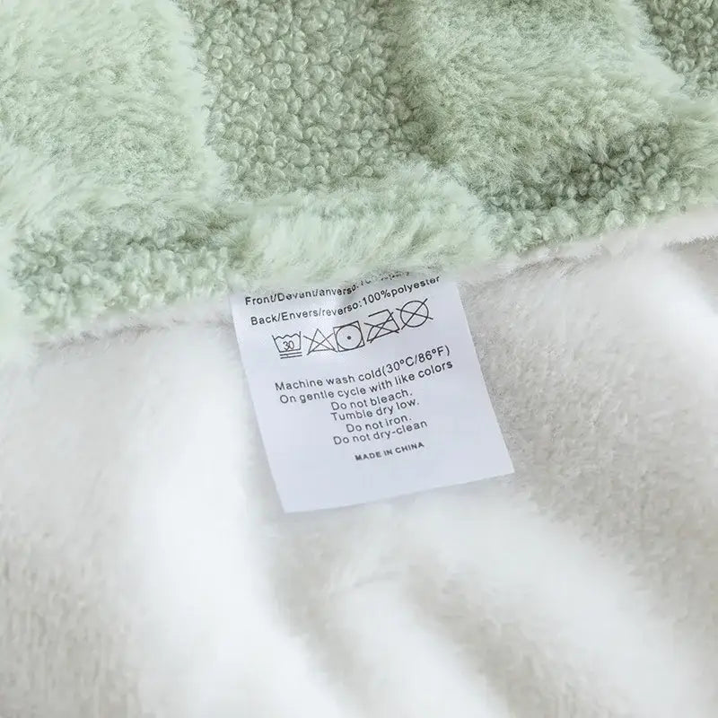 Soft mint-green and white plush geometric jacquard flannel sofa cover with textured fluffy surface for living room decorbites