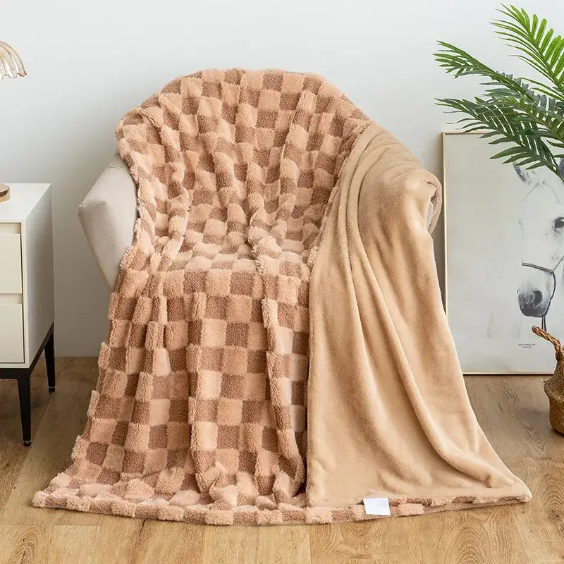 A cozy beige and tan checkered plush throw blanket with a soft textured surface complementing decorbites geometric jacquard sofa cover