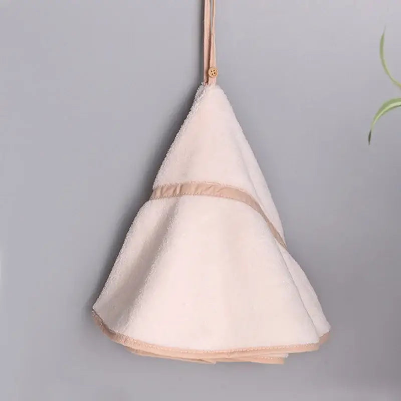 A soft off-white hand towel with beige trim and loop from decorbites coral velvet hand towel set for bathroom decor