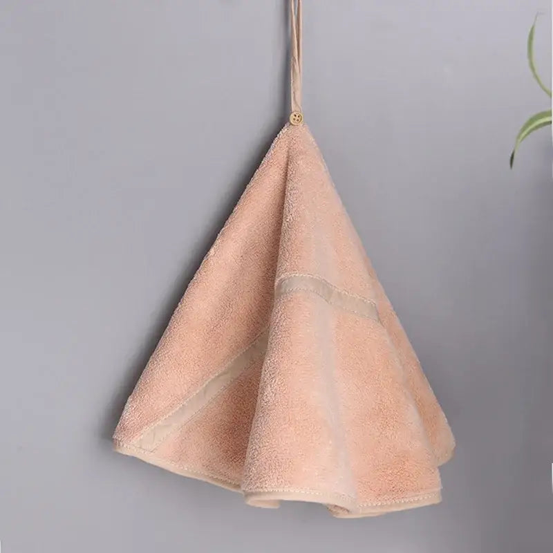 A soft peach-colored hand towel with plush coral velvet and a hanging loop from the decorbites coral velvet set