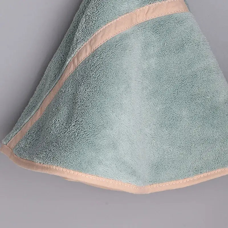 A soft mint green terry cloth hand towel with peach stitched trim from the decorbites coral velvet hand towel set