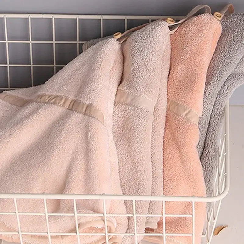 Soft plush coral velvet hand towels in pink and gray with beige trim and wooden toggles for bathroom decorbites coral velvet