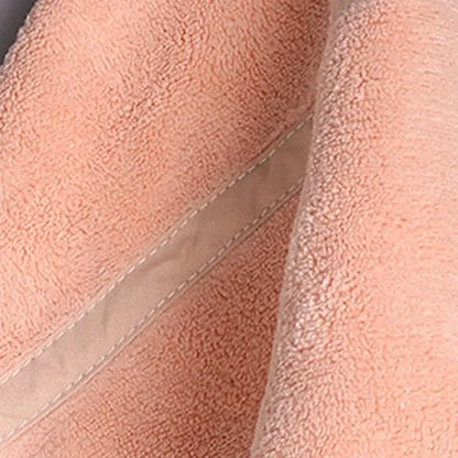 Soft peach-colored terry cloth hand towel with beige stitched seam from decorbites coral velvet hand towel set