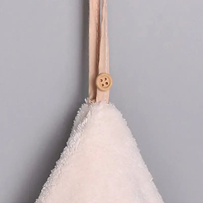 Off-white microfiber hand towel with fluffy texture and beige strap with wooden button in decorbites coral velvet set