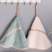 Two soft plush mint green and off-white coral velvet hand towels with beige trim and wooden button straps by decorbites