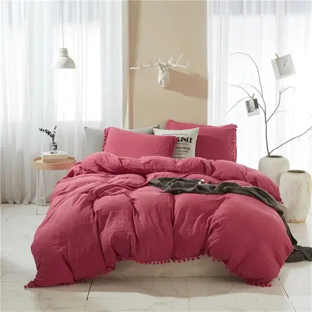 Cozy raspberry-colored quilted duvet cover set with soft tassels along edges for a stylish bedroom cover set