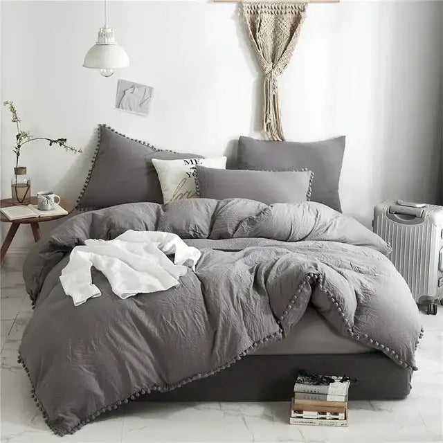 Gray textured duvet cover set with pom-pom trim highlighting soft fabric and stylish design for bedroom use