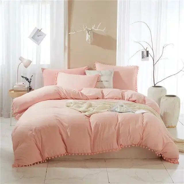 Pink quilted duvet cover set with pom-pom trim showcasing a stylish cover set for bedroom decor
