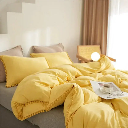 Mint green quilted duvet cover set with yellow pom-pom trim featuring soft textured fabric for bedroom use