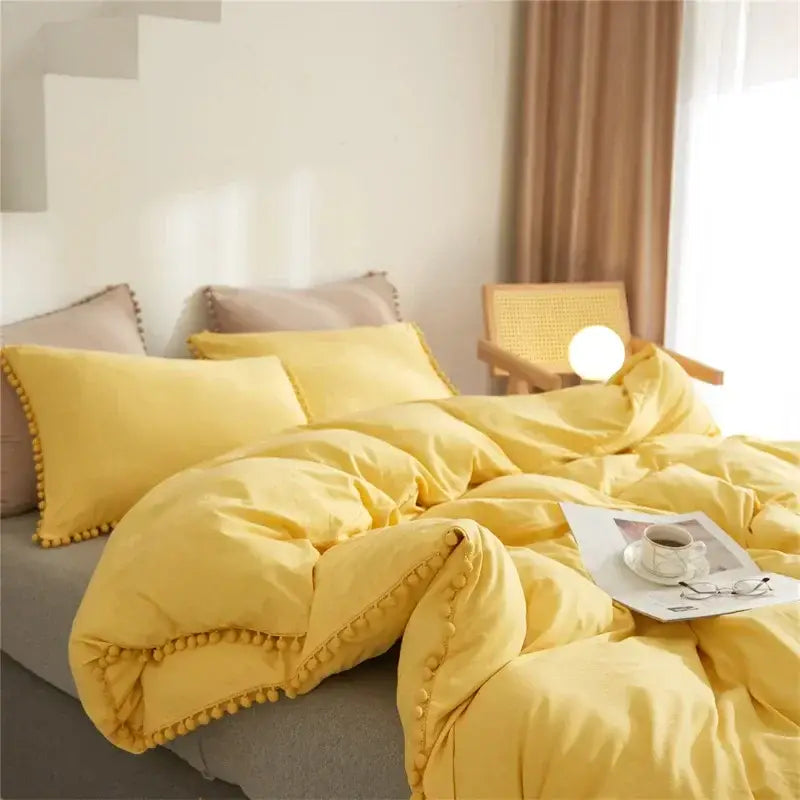 Mint green quilted duvet cover set with yellow pom-pom trim featuring soft textured fabric for bedroom use