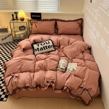 Pink ruffled quilted bedding set with black ribbon ties featuring decorbites cotton embroidery for bedroom decor