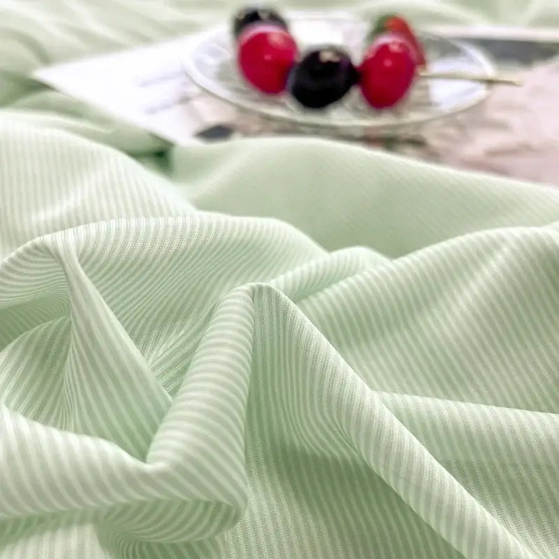Mint green and white striped ribbed fabric of decorbites cooling massage blanket for bedroom comfort and cooling
