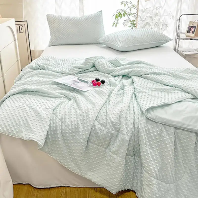 Light mint green quilted decorbites cooling massage blanket with textured raised dot pattern for bedroom comfort