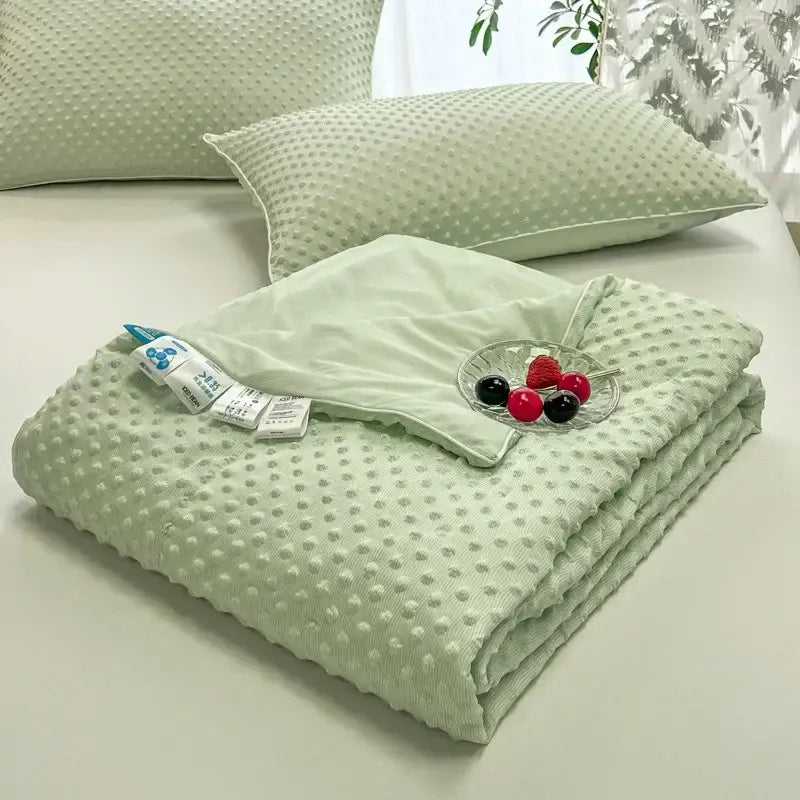 Soft mint green quilted decorbites cooling massage blanket with textured raised dot pattern for bedroom comfort