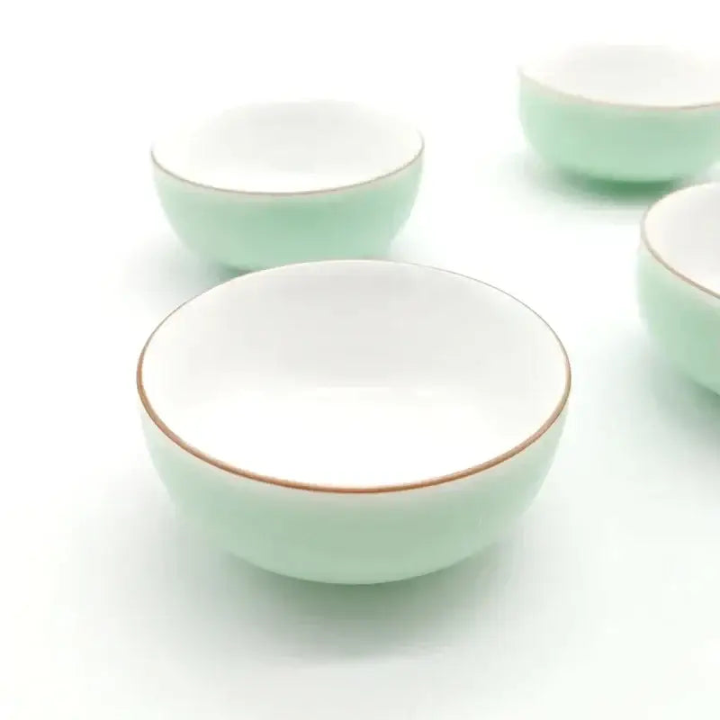 Set of four mint green and white celadon tea cups with gold rim glossy porcelain decorbites celadon tea cup set