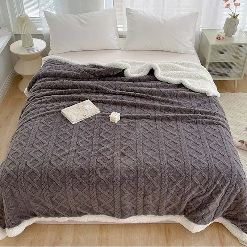 A cozy gray knit decorbites coral fleece blanket with plush white fleece lining and diamond-patterned texture for warmth