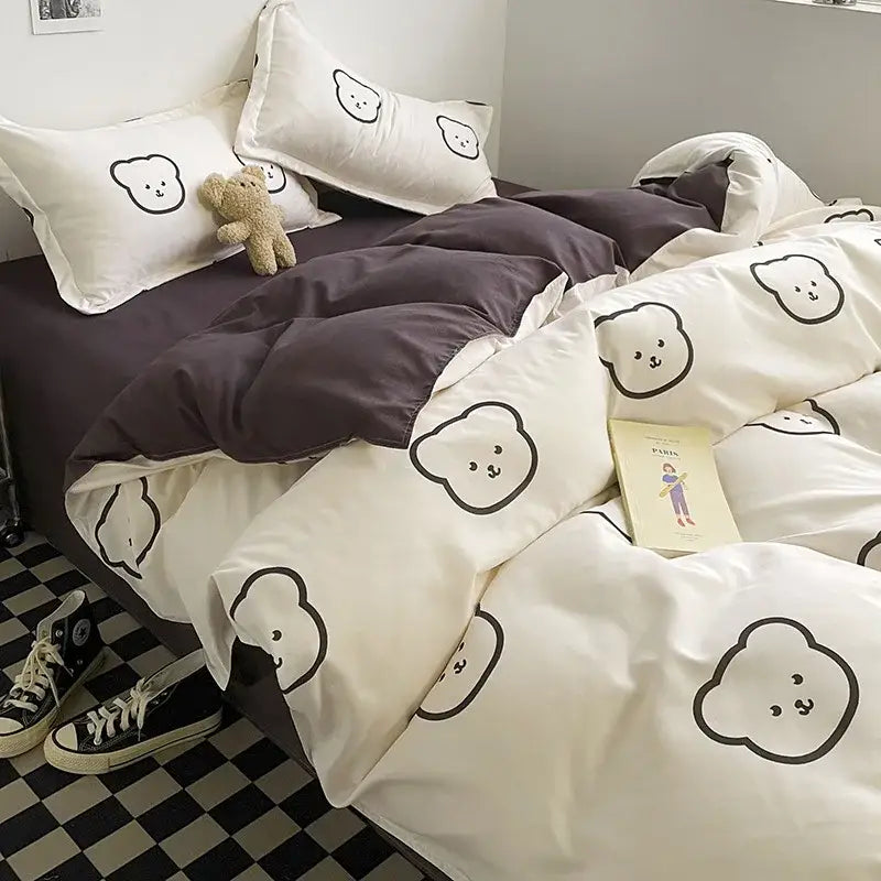 White cotton duvet set with black outlined bear faces and matching pillowcases in mint green and white cartoon print decorbites bedding set