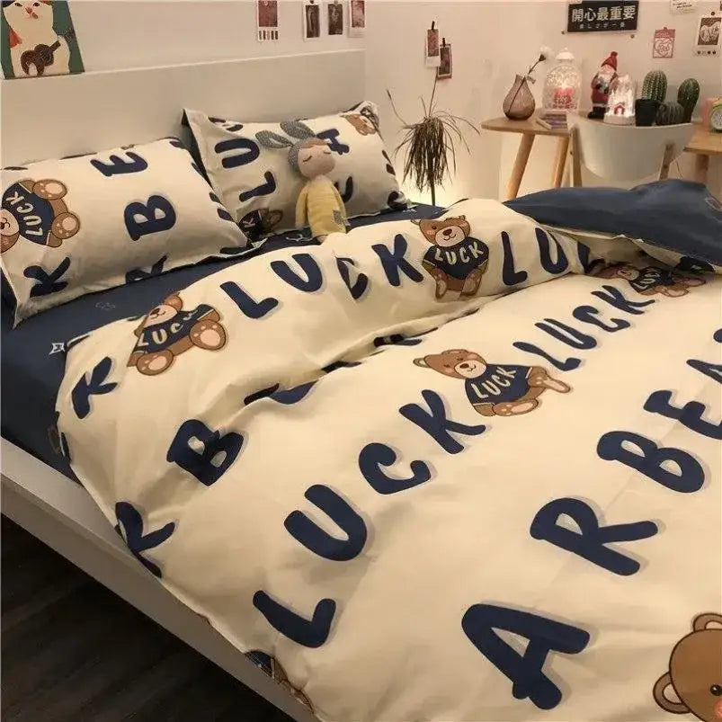 Cream-colored bedding set with playful cartoon print bears wearing luck shirts and bold navy lettering for decorbites