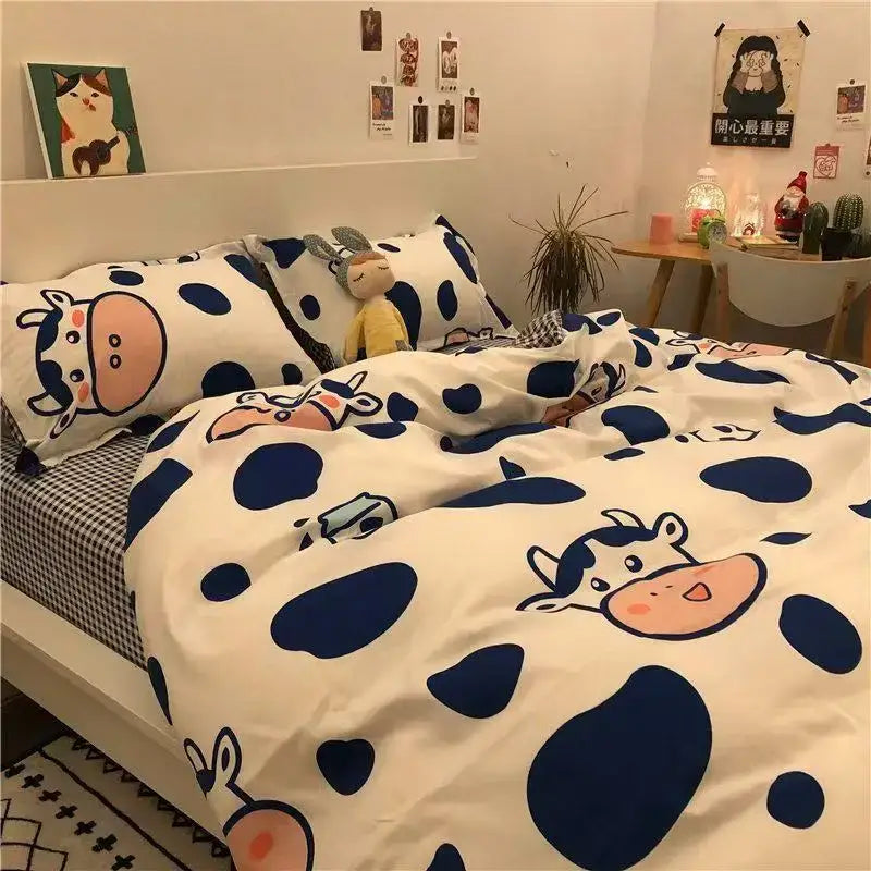 Cute white and navy blue cow-patterned bedding set with cartoon print from decorbites for playful bedroom decor