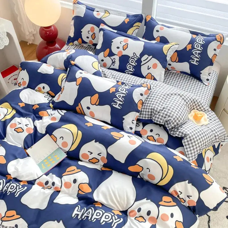 Navy blue bedding set with cartoon print white penguins wearing yellow hats and orange happy text for decorbites bedroom