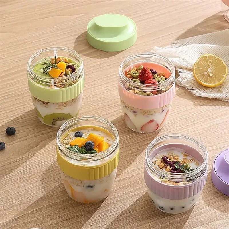 Mint green and yellow decorbites breakfast cup glass jars with ribbed silicone lids filled with fruit and granola parfaits