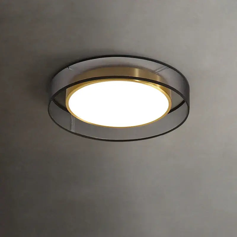 Modern 16w copper ceiling light with concentric brushed brass and matte black rings and warm white frosted glass center
