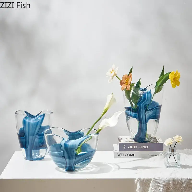 Clear glass vase with swirling blue striped patterns holding delicate flowers for modern living room decorbites decor