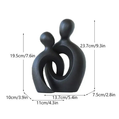 Black matte ceramic modern abstract couple love sculpture depicting two stylized figures embracing for decorbites couple love