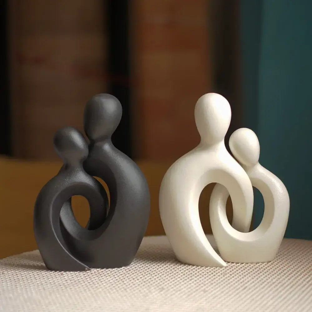 Modern abstract ceramic couple love sculpture featuring matte dark gray and glossy white minimalist figurines decorbites couple love