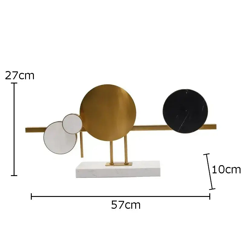 Modern abstract circular marble sculpture with gold-toned brass frame and white black gold marble discs on white base decorbites circular