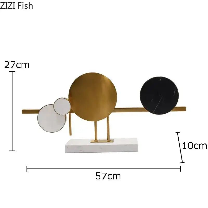 Modern abstract circular marble sculpture with gold-toned metal frame and white black marble on white marble base decorbites circular marble